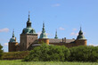 Exterior view with summer greenery in the foreground of the Swedish Kalmar Castle with the oldest buildings erected at the end of the 12th century.