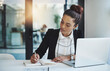 © Donson/peopleimages.com - Success is a consistent, daily effort. Shot of a young businesswoman making notes at her desk in a modern office.