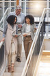 © Tamline L/peopleimages.com - Meeting, walking in office and business people on stairs in discussion for planning, strategy and chatting at work. Teamwork, corporate workplace and happy workers with notebook, documents and report