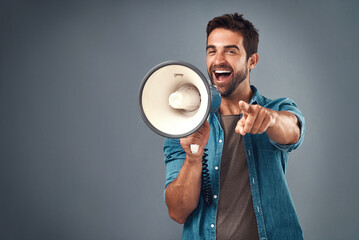 Aufkleber - Youre our winner of the day. Studio shot of a handsome young man using a megaphone against a grey background.
