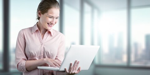 Happy young smart business woman with laptop