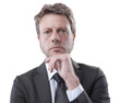 © stokkete - Confident business executive thinking with hand on chin