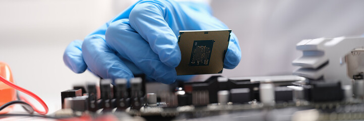 Poster - Technician connects a CPU microprocessor to motherboard socket