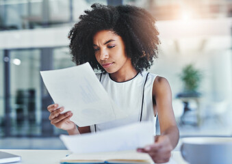 Canvas Print - Looking through stats. Cropped shot of an attractive young businesswoman working in her office.