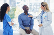 © Sharne T/peopleimages.com - Doctor woman, patient and stethoscope at consultation in hospital for healthcare or health insurance. Black man and professional nurse talking about cardiology, breathing and advice for healthy life