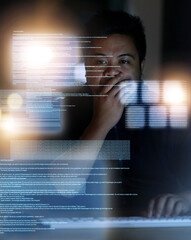 Planning his next move. Shot of a hacker cracking a computer code in the dark.