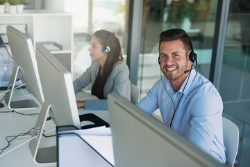 Aufkleber - My customers can count on us to care. Portrait of a happy and confident young man working in a call center.