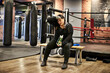 A female boxer taking a rest during her workout at the boxing gym.