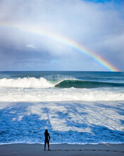 A Surfer Watching Perfect Waves At Pipeline With A Rainbow And Palm Shadows Over The Water Surf