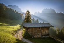 Sunrise Over A Mountain Meadow And Hut In The Dolomites