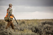 © Cavan Images - Man upland bird hunting with his dogs in the plains of northeastern Montana.