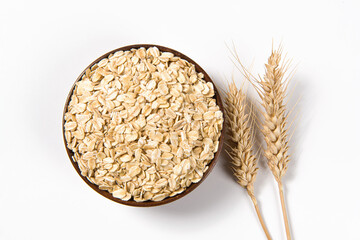 Wall Mural - Oat flakes with wheat ears isolated on white background.