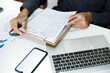 © Lek - Asian business man working on desk in office looking at financial information and checking financial chart, he is an executive of new business management and financial Advisor
