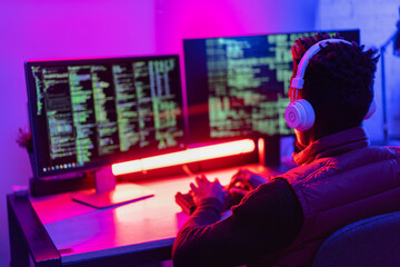 Software developer coding on his computer. Coding and hacking concept..
