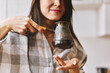 © olga pink - Morning begins with coffee. Asian woman sniffs fresh coffee in cezve after cooking Enjoy moment