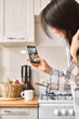 © olga pink - Young beautiful Asian woman using smartphone taking digital picture on screen of healthy food