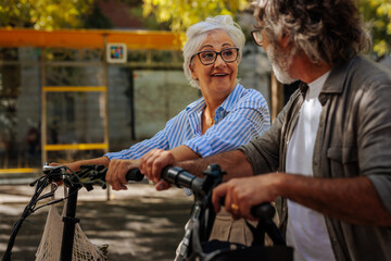 Wall Mural - Modern senior couple with alternative transportation.