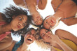 © olly - five young women at the sea, in a circle make funny faces