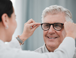 Wall Mural - Optometry, ophthalmology and optometrist fitting glasses on senior man patient or happy client during appointment. Doctor, consultation and eyewear or spectacles for an elderly male for vision