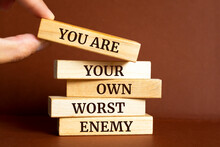 Wooden blocks with words 'You Are Your Own Worst Enemy'.