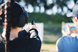 © Azee Jacobs/peopleimages.com - Woman, gun and learning to shoot outdoor with instructor at shooting range for target training. Safety and security with hand teaching person sport game or aim with gear and firearm for focus
