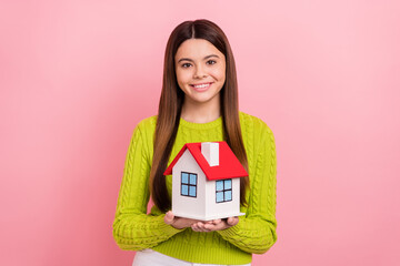 Canvas Print - Photo of friendly cheerful girl arms hold showing little house isolated on pink color background