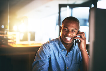 Poster - Hows work going Great. Shot of a young businessman using a mobile phone during a late night in a modern office.
