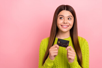 Canvas Print - Photo of cheerful girl beaming smile hands hold plastic debit card isolated on pink color background