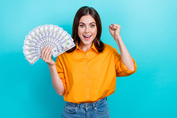 Sticker - Portrait of impressed ecstatic girl bob hairstyle dressed yellow shirt hold money clench fist scream yes isolated on blue color background