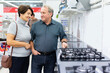 © caftor - Elderly man and elderly woman choose stove in store