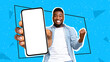 © Prostock-studio - Black man celebrating success with clenched fist and cell phone