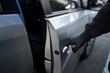 © PBXStudio - Close-up shot of a car thief hand pulling the handle of the car. Car theft concept.