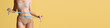 © master1305 - Losing weight, diet. Cropped image of slim female body in underwear on yellow background. Model measuring body. Body and skin care, fitness, beauty, health, wellness. Banner, flyer. Copy space for ad