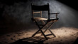 © YarikL - The director's chair stands in a beam of light with an backlight. Free chair. Concept of selection and casting. Shadow and light.