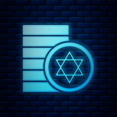 Sticker - Glowing neon Jewish coin icon isolated on brick wall background. Currency symbol.  Vector