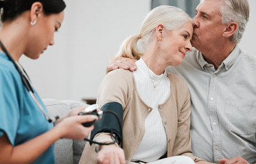 Wall Mural - Kiss, nurse or old couple with blood pressure test consulting in hospital to monitor heart healthcare. Doctor, hypertension consultation or medical physician with a happy patient for examination