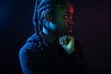 Colorful portrait of thoughtful cool woman with dark skin and braided hair