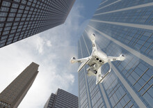 Unmanned Aircraft System Quadcopter Drone In The Air Among The City And Corporate Buildings.