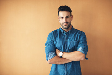 Stand up for who you are. Studio portrait of a handsome young man posing against a yellow background.