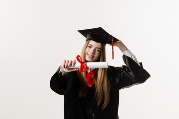 Wall Mural - Masters degree diploma with red ribbon in hands of graduate girl in black graduation gown on white background. Graduate girl is graduating high school and celebrating academic achievement.