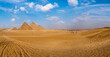General panoramic view of four pyramids  in Giza, Cairo, Egypt. Real view from the desert, side view.