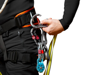 Wall Mural - High-altitude equipment, carabiners, block rollers, on a man's belt. Telecommunications, work at height, industrial mountaineering, height, insurance. Close-up. isolated