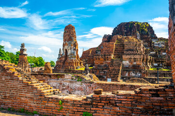 Ruins of ancient city and temples Ayutthaya, Thailand. Old kingdom of Siam. Summer day with blue sky. Famous tourist destination, spiritual place near Bangkok.