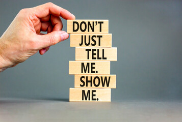 tell or show symbol. concept words do not just tell me, show me on wooden blocks. beautiful grey tab