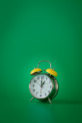 Wall Mural - Retro silver alarm clock. 1:00.  am,  pm. Green background.