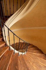 Narrow spiral stairs in warm colors