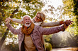 © lordn - Cheerful pensioners enjoying their life together having fun outdoors in the park