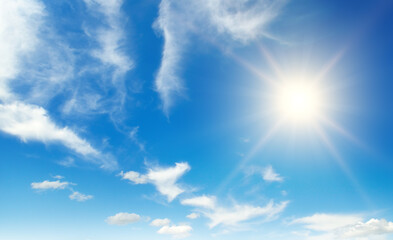 Wall Mural - bright sun on beautiful blue sky with white clouds.