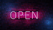 pink open neon sign on brick wall