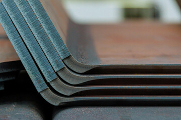 Bending of sheet metal on a hydraulic bending machine. Production of metal products in a production workshop.